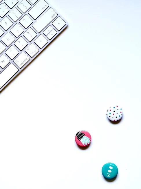 A modern tablet displaying a search engine logo next to a wireless keyboard on a wooden desk.